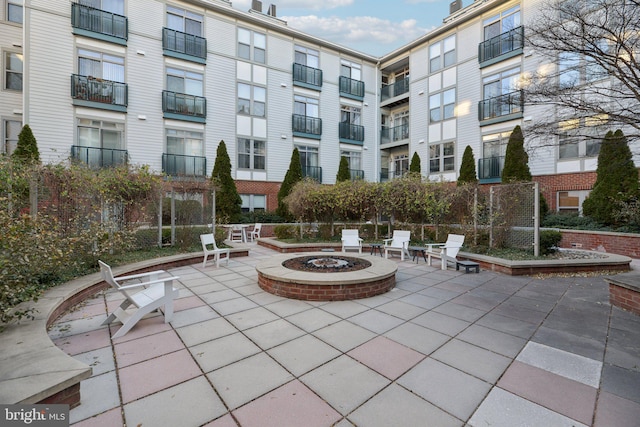 surrounding community featuring a patio and an outdoor fire pit