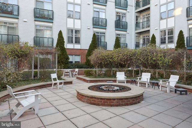 surrounding community featuring a patio and an outdoor fire pit