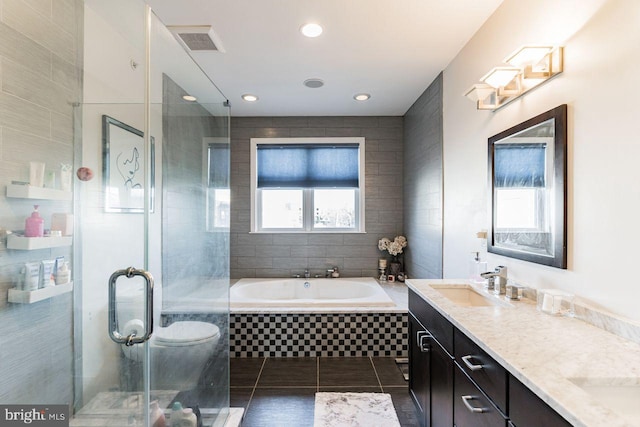 full bathroom featuring tile patterned flooring, vanity, toilet, and plus walk in shower