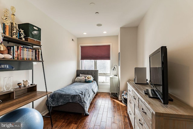 bedroom with dark hardwood / wood-style floors