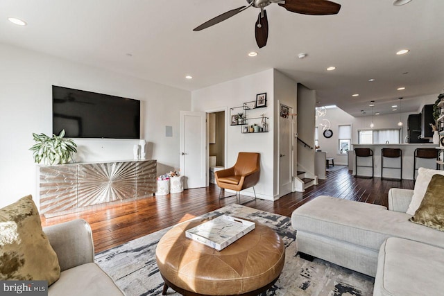 living room with ceiling fan and hardwood / wood-style floors