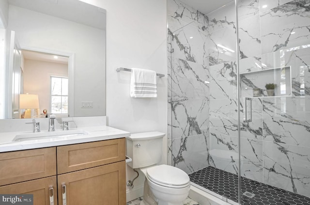 bathroom with toilet, an enclosed shower, and vanity