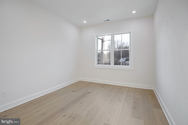 spare room with light hardwood / wood-style flooring