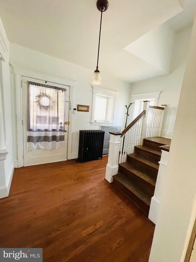 foyer with dark hardwood / wood-style flooring and radiator