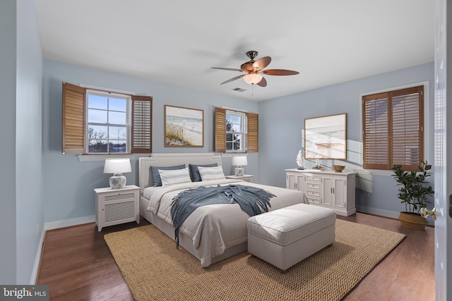 bedroom with ceiling fan and dark wood-type flooring