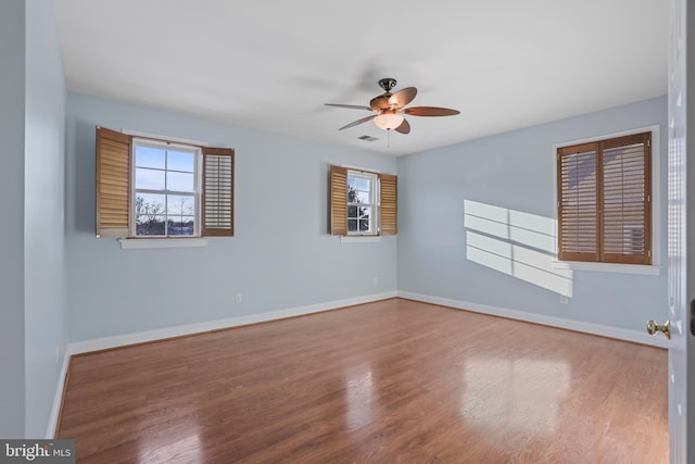 unfurnished room with ceiling fan and hardwood / wood-style flooring