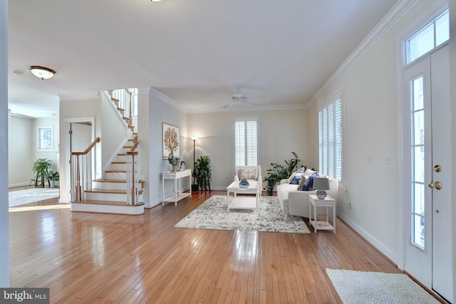 living room featuring ornamental molding, ceiling fan, and light hardwood / wood-style flooring