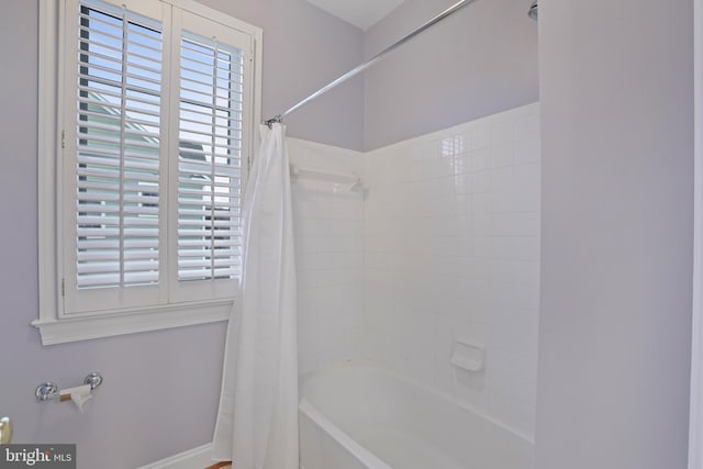 bathroom with shower / bathtub combination with curtain