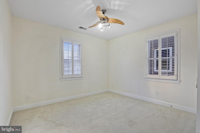 carpeted spare room with ceiling fan