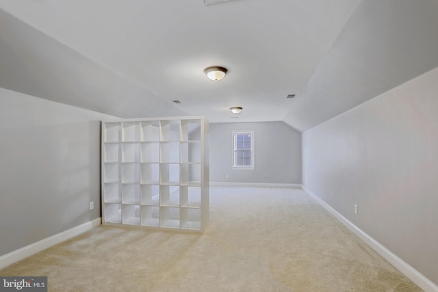 additional living space with lofted ceiling and carpet flooring