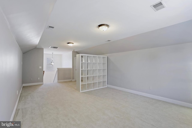 bonus room with light carpet and lofted ceiling