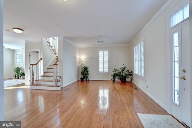 entrance foyer with ceiling fan, light hardwood / wood-style flooring, and ornamental molding