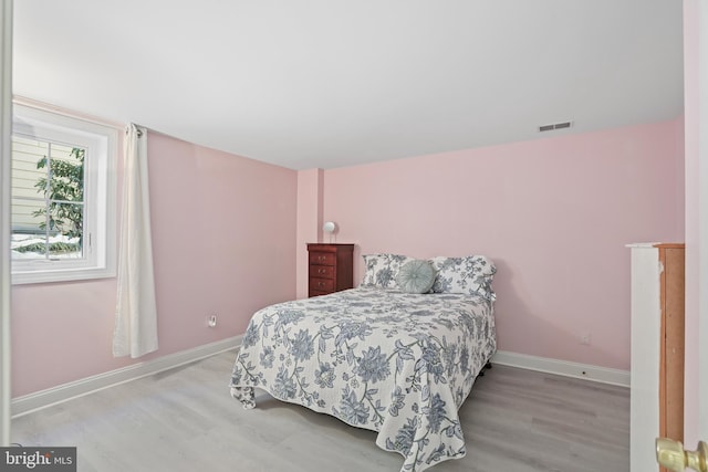 bedroom with light hardwood / wood-style floors