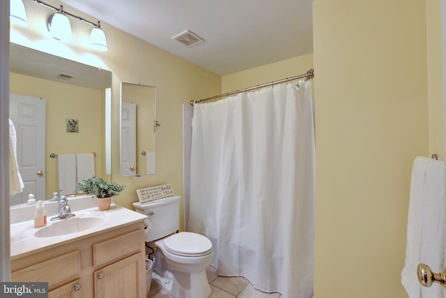 bathroom featuring toilet, tile patterned floors, and vanity