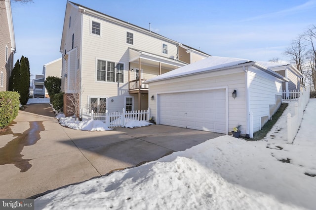 view of front of property featuring a balcony and a garage