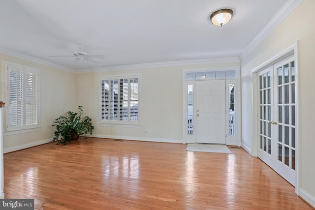 foyer entrance with french doors, ceiling fan, ornamental molding, and light hardwood / wood-style floors