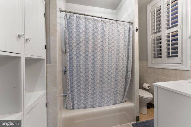 full bathroom featuring toilet, vanity, tile walls, and shower / bath combination with curtain