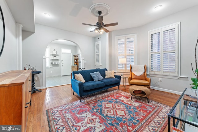 living room featuring ceiling fan and light hardwood / wood-style flooring