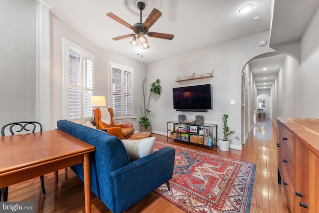 living room with ceiling fan and light hardwood / wood-style floors