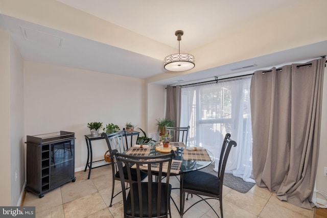 dining space featuring light tile patterned flooring