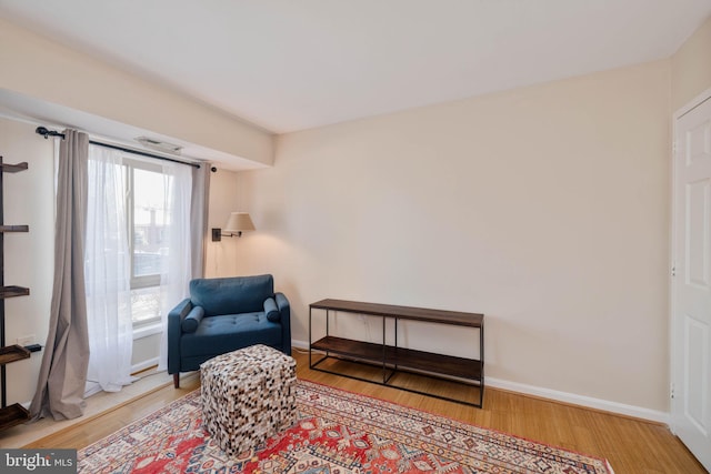 sitting room with hardwood / wood-style floors