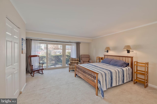 carpeted bedroom featuring a closet, access to exterior, and ornamental molding