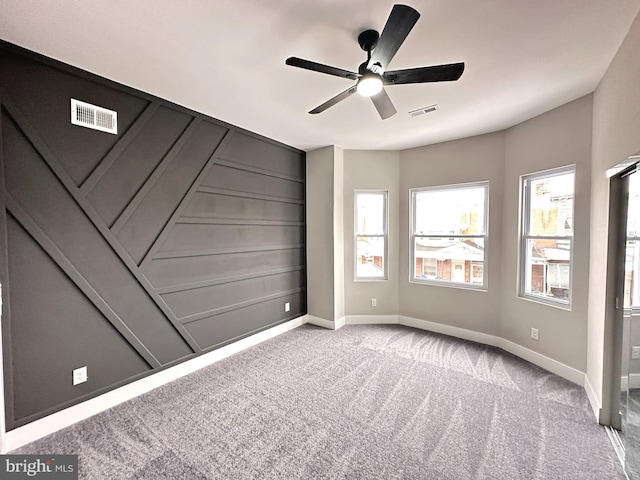 spare room featuring ceiling fan and light colored carpet