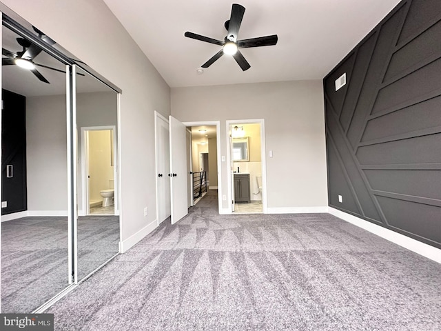 unfurnished bedroom featuring ceiling fan, light colored carpet, connected bathroom, and a closet