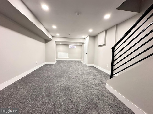 basement featuring dark colored carpet