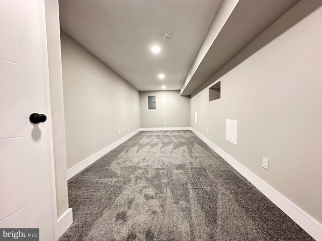 basement with carpet flooring and electric panel