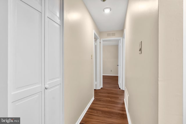 hallway with dark hardwood / wood-style flooring