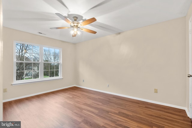 empty room featuring hardwood / wood-style flooring and ceiling fan