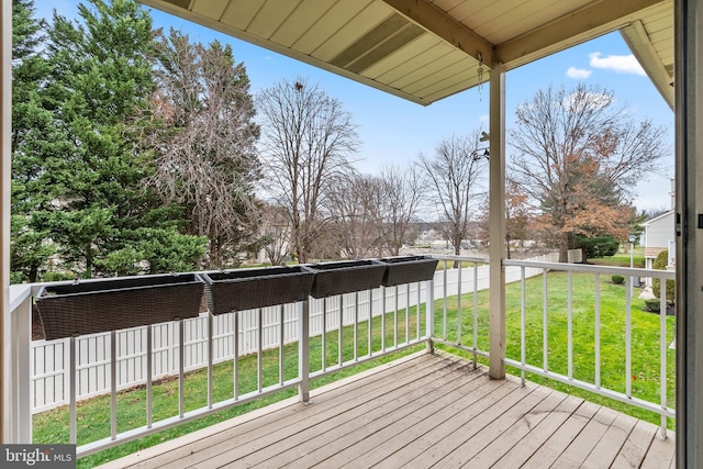 wooden deck featuring a lawn