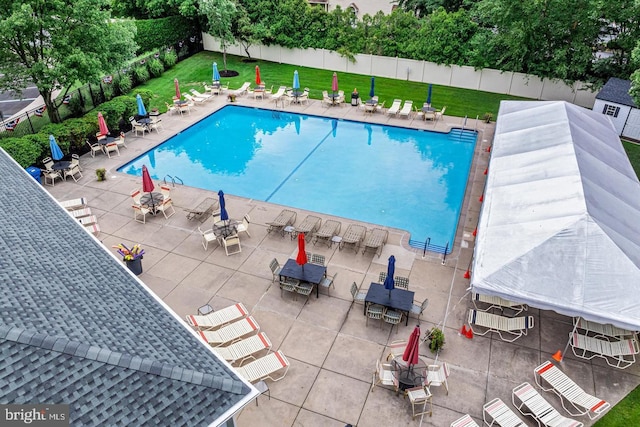 view of swimming pool with a patio area and a lawn