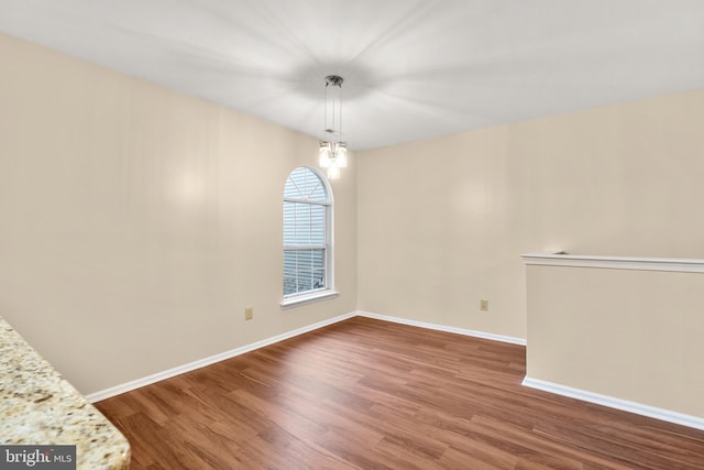 interior space with dark hardwood / wood-style flooring and a notable chandelier