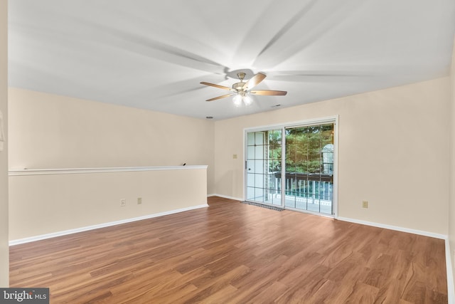 empty room featuring wood-type flooring and ceiling fan