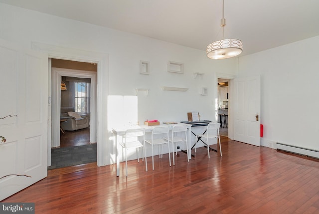 dining space with baseboard heating and dark hardwood / wood-style floors