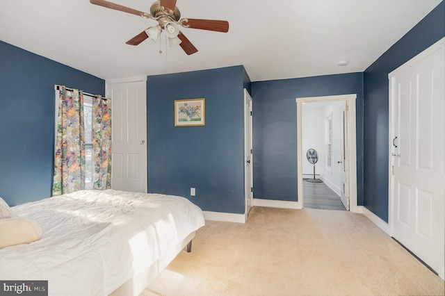 bedroom with light carpet and ceiling fan