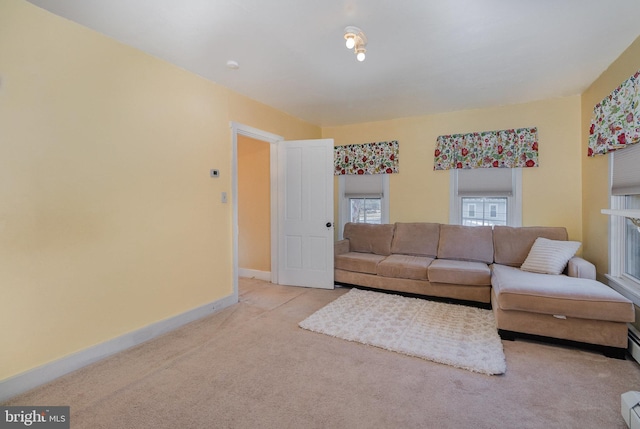 living room with light carpet and baseboard heating