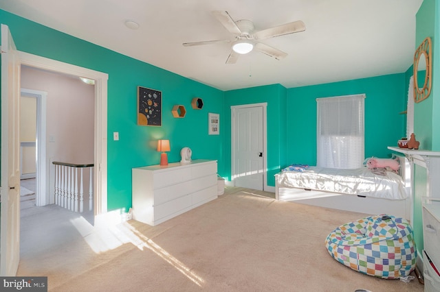 bedroom with light carpet and ceiling fan