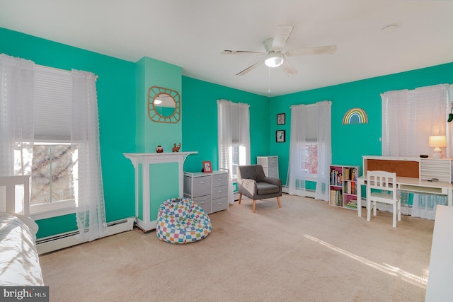 living area featuring ceiling fan, baseboard heating, and light colored carpet