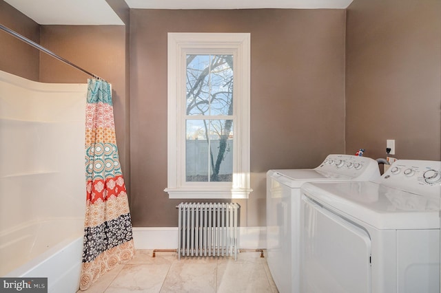 laundry area featuring washer and dryer and radiator heating unit