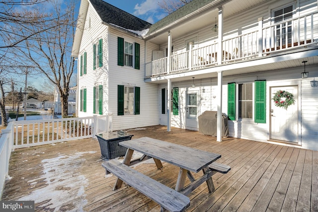 wooden terrace featuring a grill