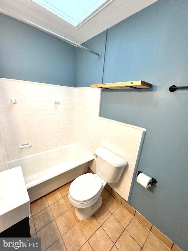 bathroom featuring tile patterned floors, vanity, and toilet