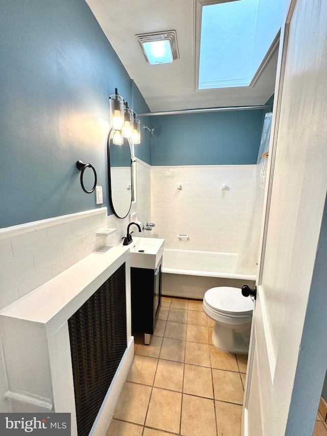 full bathroom featuring tile patterned floors, vanity, shower / bath combination with curtain, and toilet