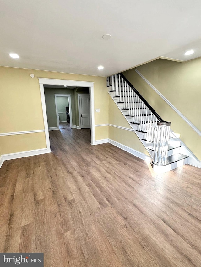 unfurnished living room with wood-type flooring