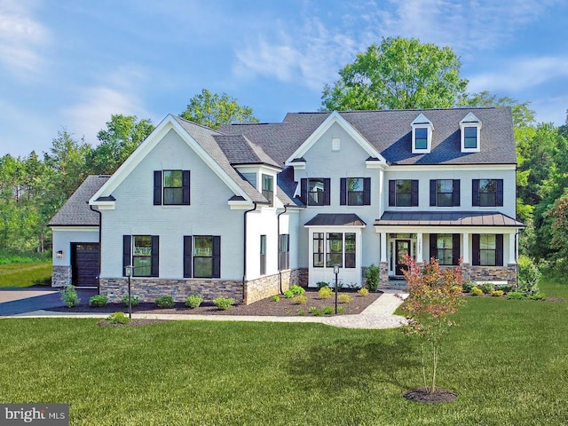 view of front of property featuring covered porch, a front lawn, and a garage