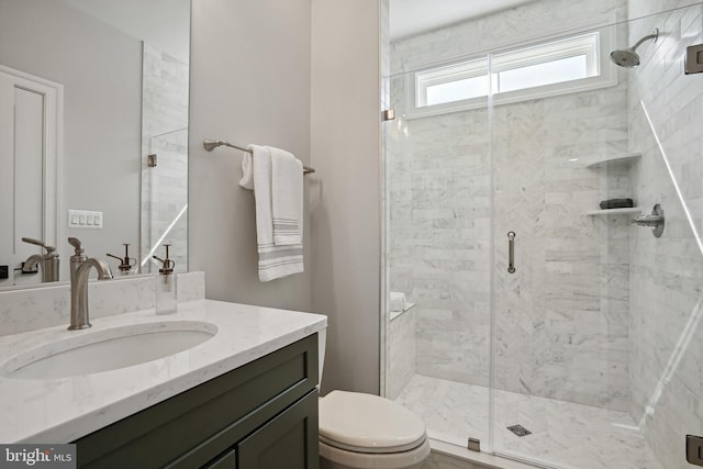 bathroom with toilet, a shower with shower door, and vanity