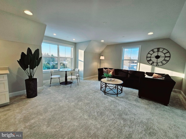 carpeted living room with lofted ceiling