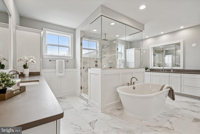 bathroom with vanity and separate shower and tub